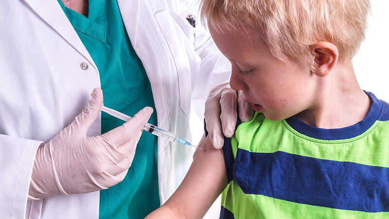 little boy is given an injection by the family doctor,diabetes kind